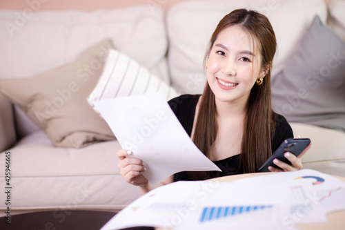 happy cheerful cute beautiful business woman sit indoors and working. casual girl working on sofa in the house.