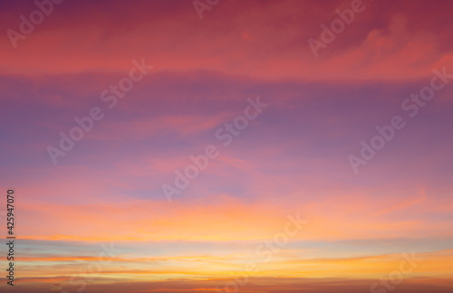 Beautiful sky painted by the sun leaving bright golden shades.Dense clouds in twilight sky in winter evening.Image of cloud sky on evening time.Evening sky scene with golden light from the setting sun