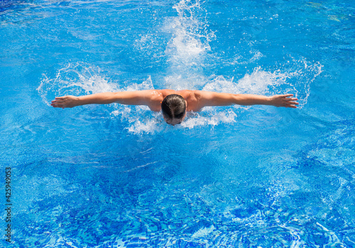 Swimmer swiming in pool with butterfly style