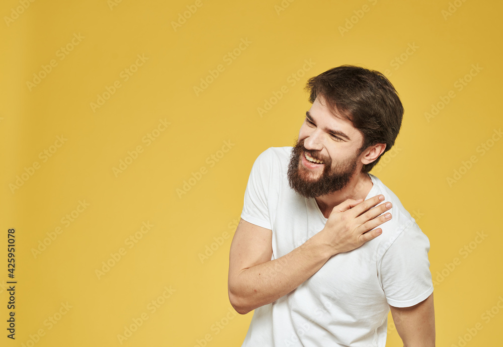 Yellow background model white t-shirt close-up brunette mustache beard Yellow background model white t-shirt close-up brunette mustache beard