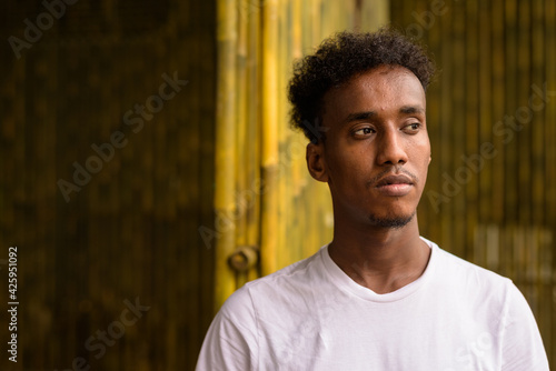 Portrait of handsome black African man with pensive attitude thinking