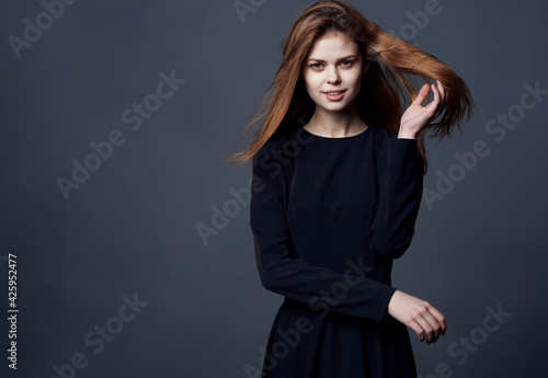 Elegant woman in black dress at evening model cropped view
