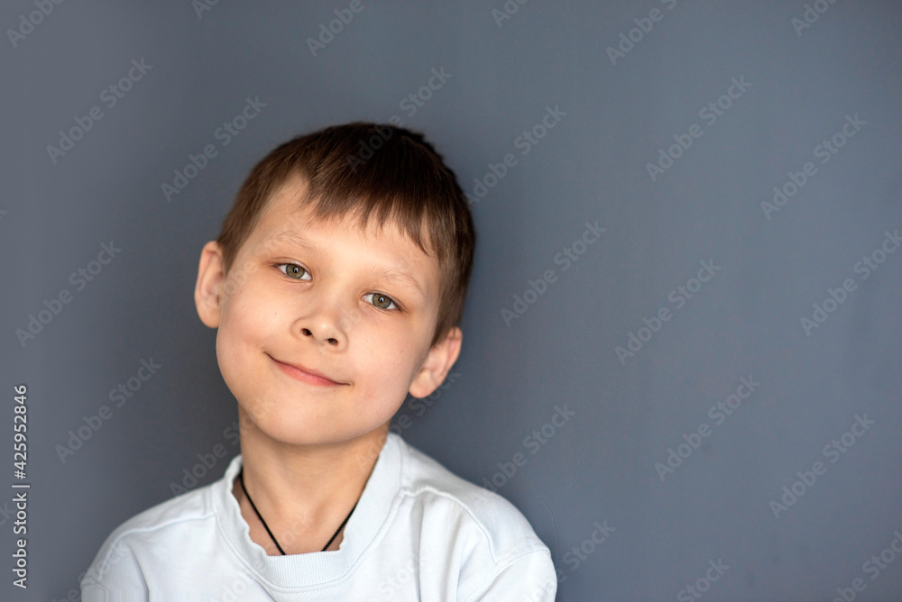 portrait of a boy 8-10 on a blue isolated background, space for text, selective focus portrait of a boy 8-10 on a blue isolated background, space for text, selective focus