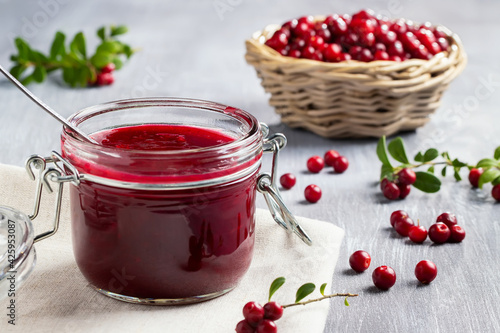 Glass jar with homemade lingonberry sauce. Canning lingonberry sauce