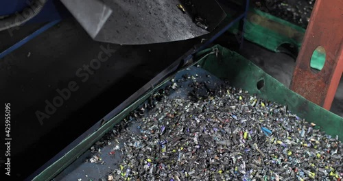 Crushed batteries fall into the tray in a heap. Sorting, recycling and disposal. Environmental protection concept.