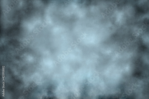 Grainy background texture in turquoise tones. The effect of puffs of smoke on the canvas  darkening towards the edge of the image. 