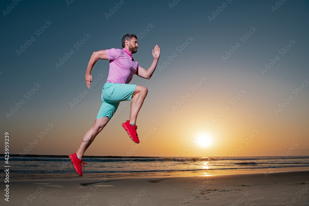 Obraz premium Athletic young man running. Healthy lifestyle concept. Dynamic jumping movement. Sport and healthy lifestyle.