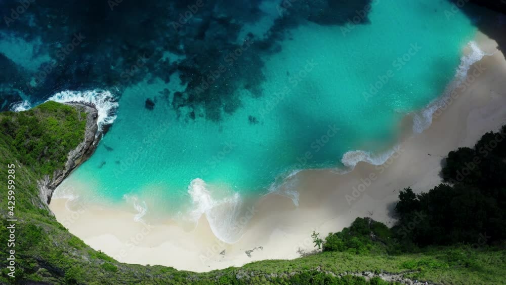 Aerial drone landscape view of the famous white sand beach of Kelingking located on the southern coast of Nusa Penida island in Bali in Indonesia. Aerial drone landscape view of the famous white sand beach of Kelingking located on the southern coast of Nusa Penida island in Bali in Indonesia.