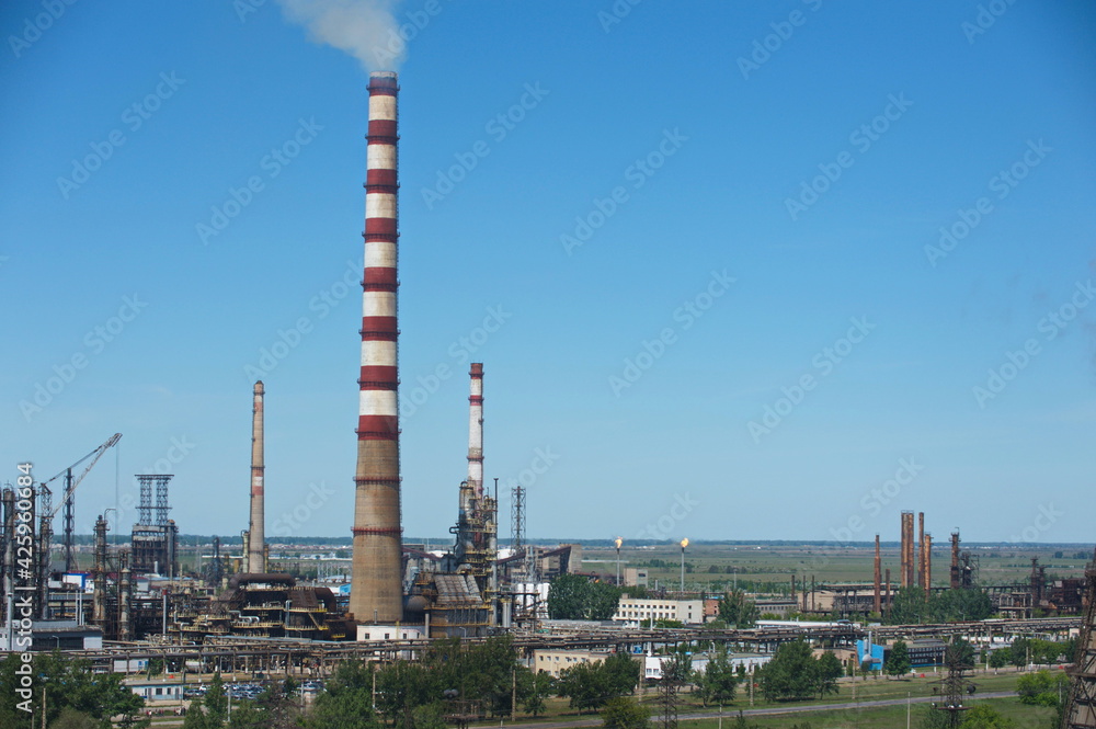 Pavlodar, Kazakhstan - 05.29.2015 : The territory of a thermal power plant with various industrial compartments and pipes.