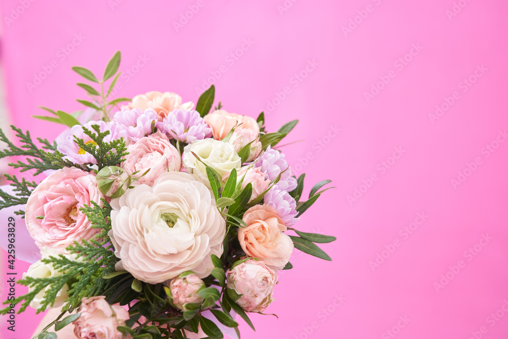 Beautiful bouquet of mixed different flowers on pink background, greeting, gift