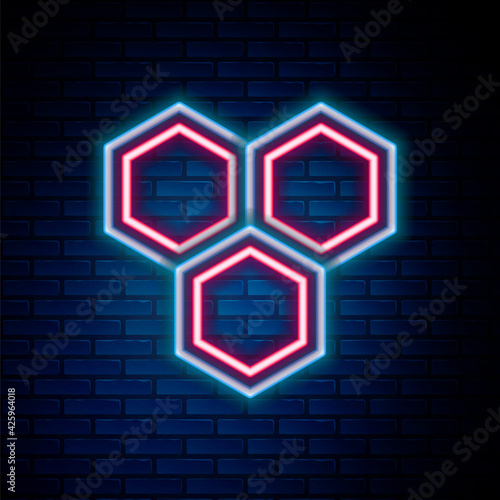 Glowing neon line Honeycomb icon isolated on brick wall background. Honey cells symbol. Sweet natural food. Colorful outline concept. Vector