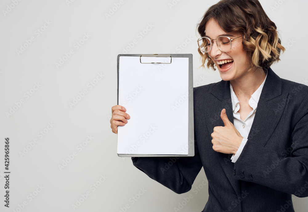 Woman shows a blank sheet of paper on a light background business finance Copy Space Woman shows a blank sheet of paper on a light background business finance Copy Space