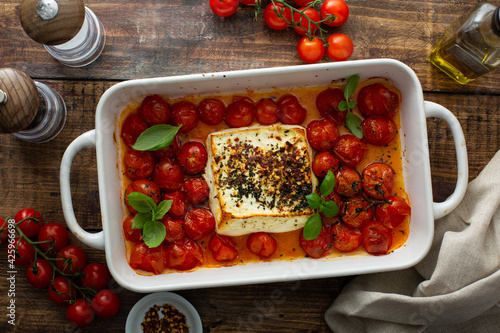 Tableau sur toile Baked feta cheese with cherry tomatoes in a pan