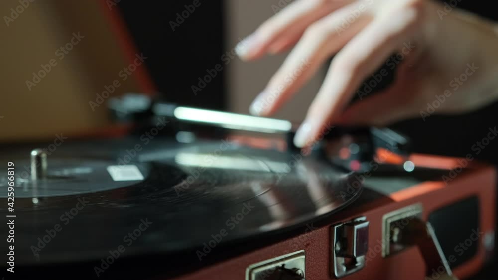 Hand adjusts the head old record player vinyl discs at home. vinyl audio player Hand adjusts the head old record player vinyl discs at home. vinyl audio player