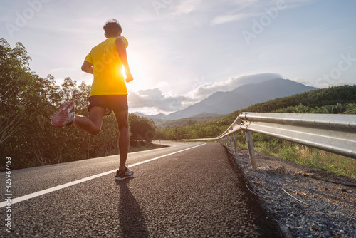 man runner athlete on the road to healthy, Young people running exercise on street.