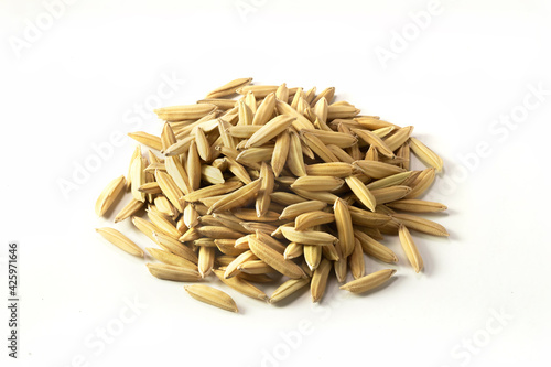 Pile of yellow gold rice. Close up of long paddy rice grains can use for background and texture. Macro of sample natural rice realistic closeup photo image.