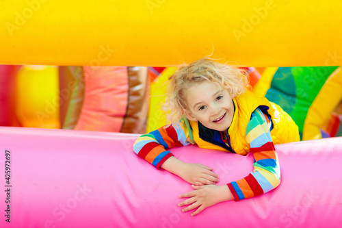 Child jumping on colorful playground trampoline

