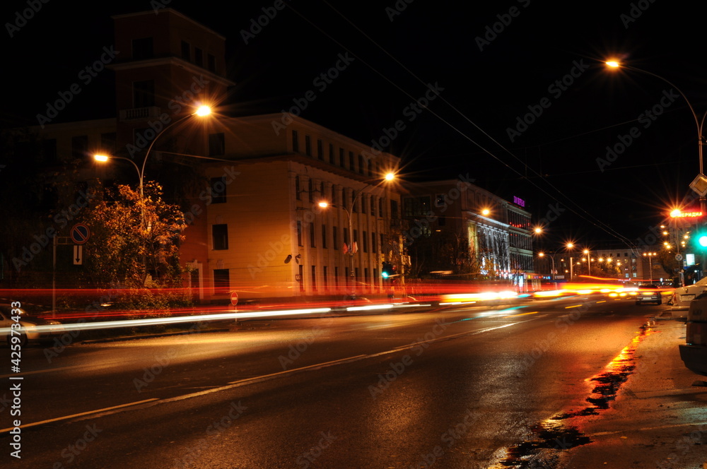 Murmansk, Russia-September 2010: Light traces of a passing trolleybus. Artistic image. Long exposure photo taken in the city. Night lights of the city, night city.