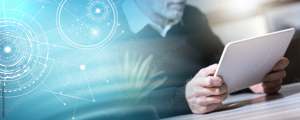 Senior man using his tablet; panoramic banner Senior man using his tablet; panoramic banner