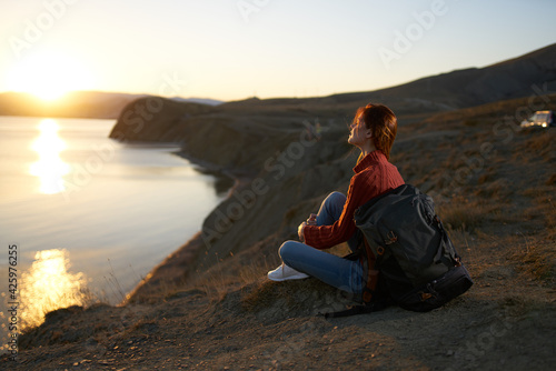 woman tourist sitting on the ground admiring nature landscape fresh air © SHOTPRIME STUDIO