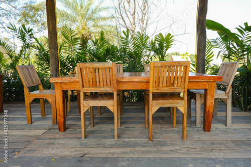 A set of wooden tables and chairs on the wooden patio in the restaurant Asian style