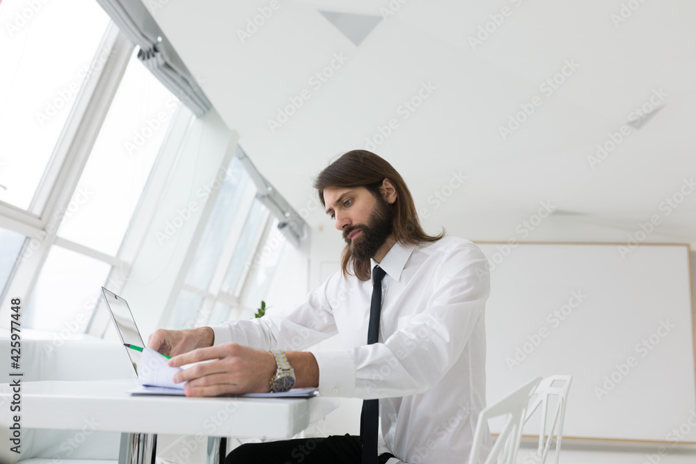 portrait of a serious man working with documents at the table
portrait of a serious man working with documents at the table