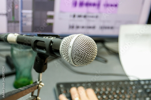 Microphone on the background of a computer monitor. Home recording Studio. 