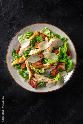 Chicken Caesar salad with lettuce and cheese, shot from the top