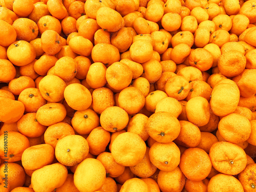 Healthy fruits, orange fruits background many orange fruits - orange fruit background in a supermarket super store