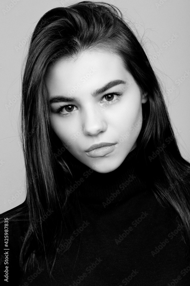 Close up portrait of young beautiful brunette woman in studio on white background. Black and white portrait. Close up portrait of young beautiful brunette woman in studio on white background. Black and white portrait.