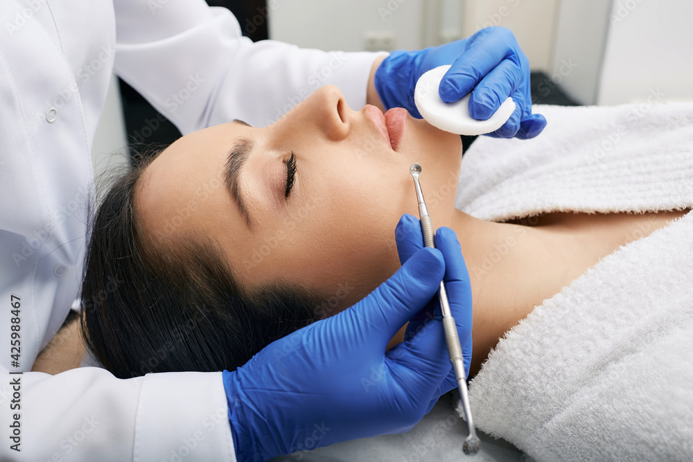 Facial cleansing. Beautiful woman having mechanical cleansing face skin from defect and remove blackhead Facial cleansing. Beautiful woman having mechanical cleansing face skin from defect and remove blackhead