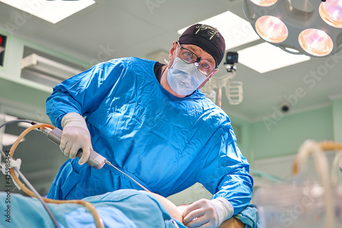 surgeon during liposuction in the operating room