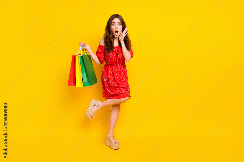 Full length photo of impressed girl arm on cheek open mouth cant believe isolated on yellow color background