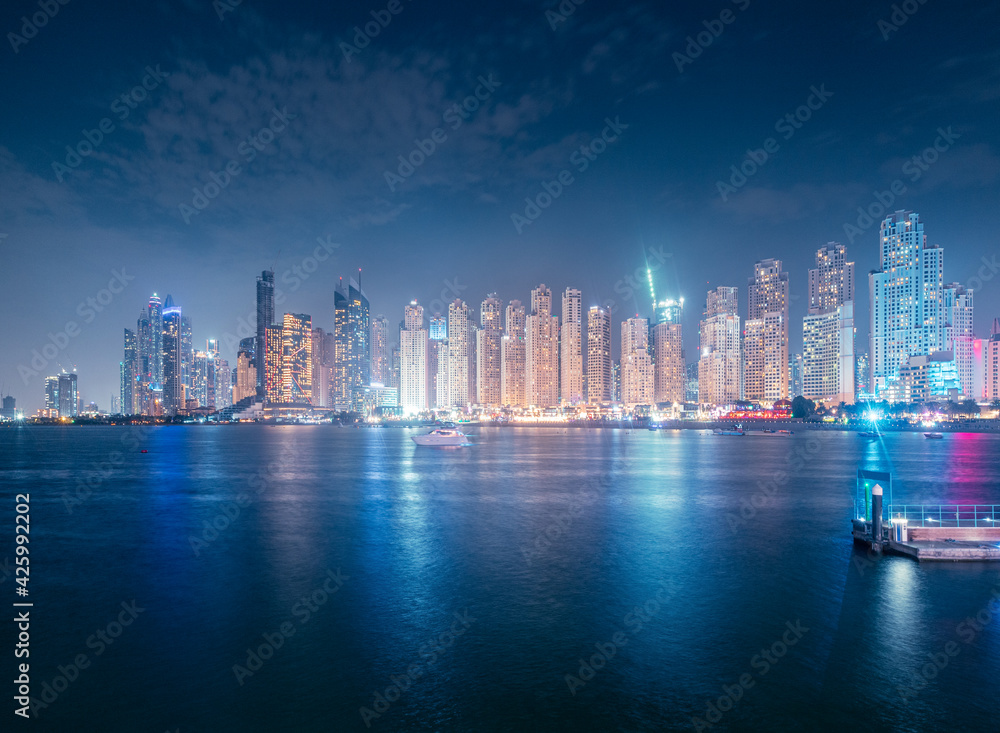Numerous hotels and residential buildings and office business centers on the seashore in Dubai, United Arab Emirates. The concept of real estate prices and tourism