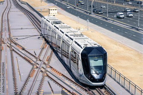 Canvas Print Hightech modern automated tram rides on the Sheikh Zayed Highway in Dubai, aerial view
