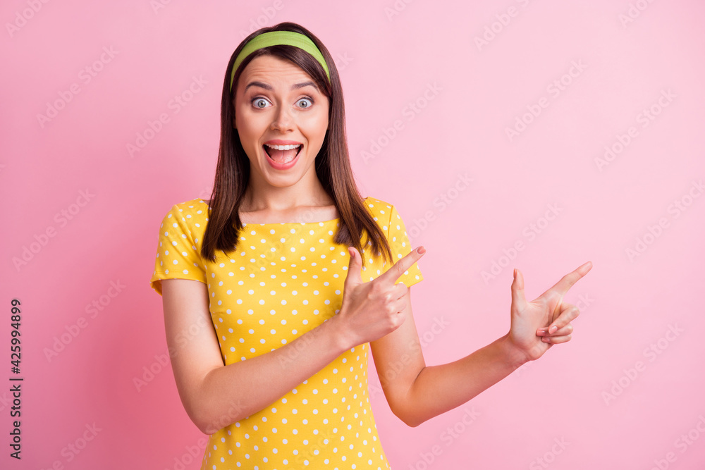 Photo of young beautiful happy shocked amazed surprised smiling girl pointing fingers copyspace isolated on pink color background Photo of young beautiful happy shocked amazed surprised smiling girl pointing fingers copyspace isolated on pink color background