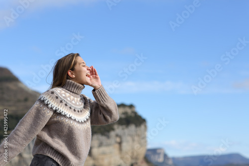 Woman shouting for echo in the mountain