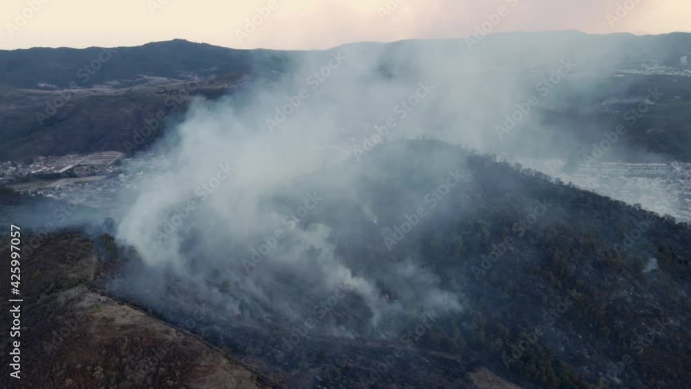 a cloud of smoke coming out of a mountain 4k
