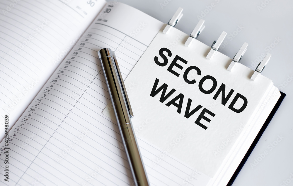 text Second Wave on the short note texture background with pen text Second Wave on the short note texture background with pen