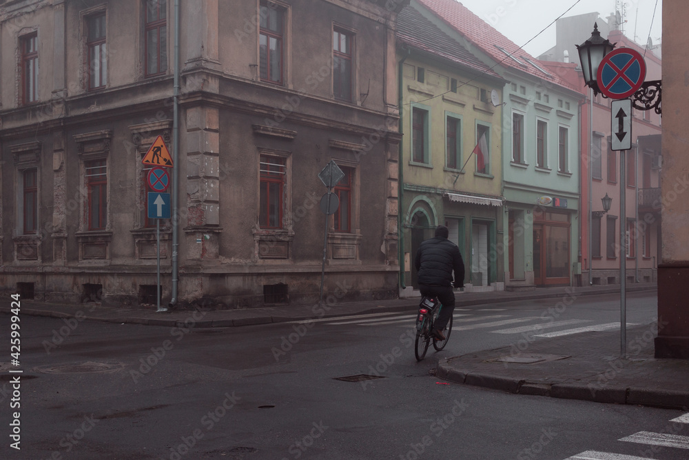 person at the misty streets of the small town