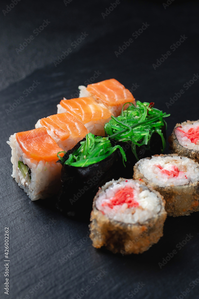 Classic sushi rolls on a dark background Classic sushi rolls on a dark background