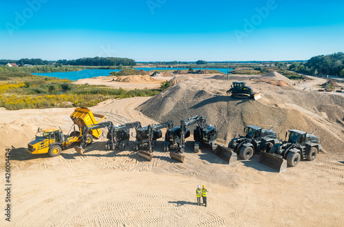 Aerial shot of a quarry with workers and machinery digging sand