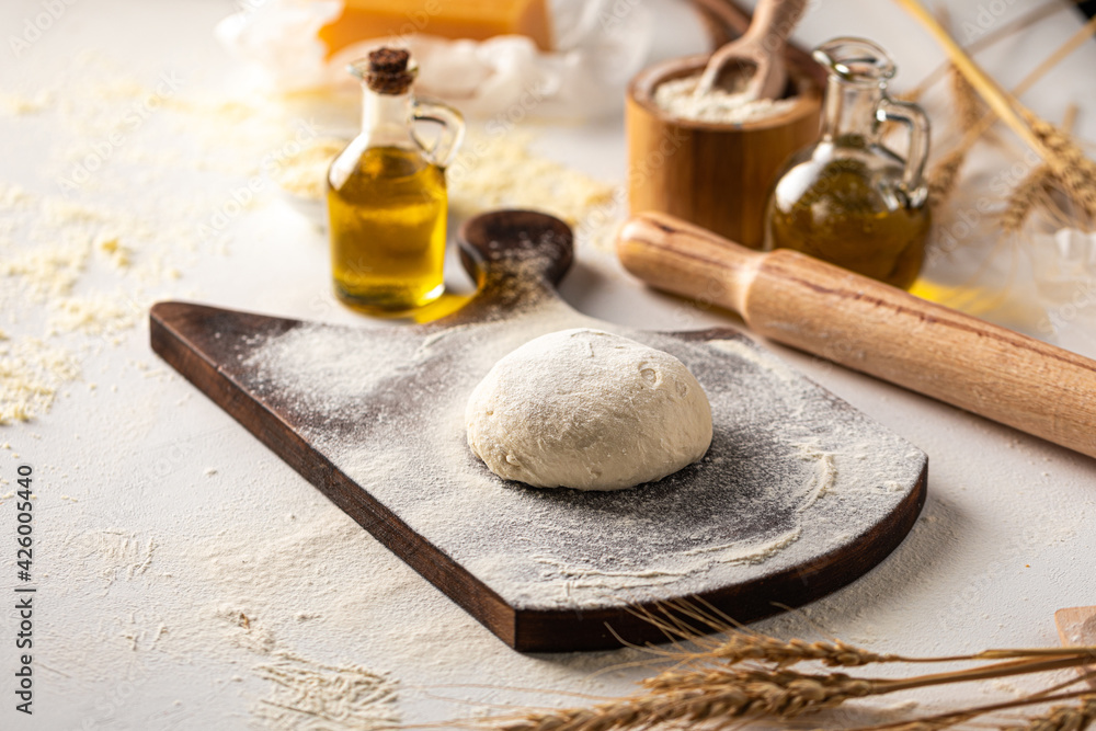 Fototapeta premium Preparation of dough with flour for kneading pizza cooking