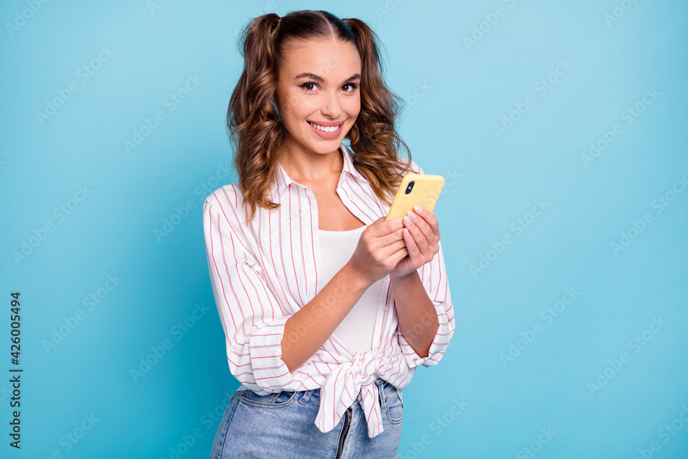 Portrait of lovely cheerful girl using device gadget chatting web smm isolated on bright blue color background Portrait of lovely cheerful girl using device gadget chatting web smm isolated on bright blue color background