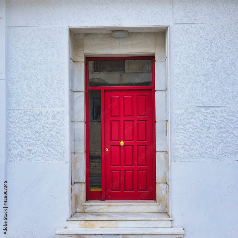 contemporary house front entrance, red painted door and marble frame