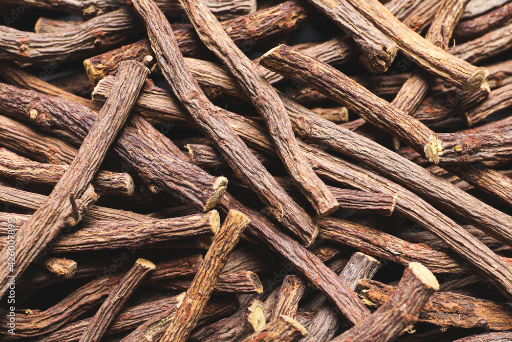 Dried sticks of liquorice root as background, top view Dried sticks of liquorice root as background, top view