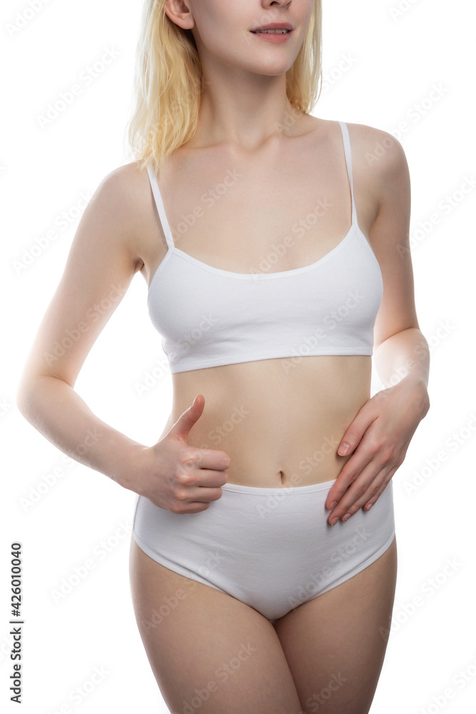 Young, healthy and beautiful blonde woman in white lingerie. Sport, fitness, diet, weight loss and healthcare concept.