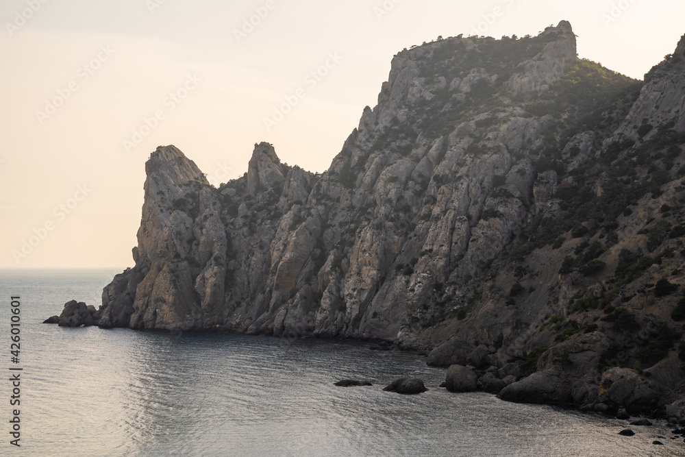 Stone rock on the coast of the peninsula in Alanya (Turkey) - view from the sea.