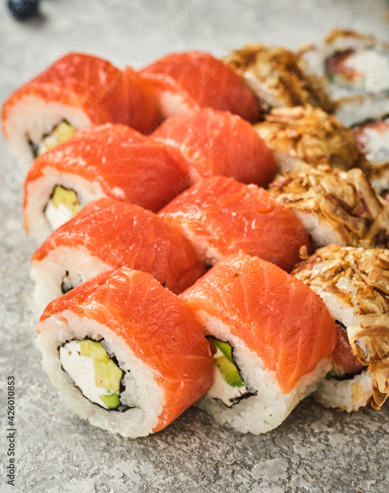 Sushi set. Uromaki with Philadelphia, with vegetables and fish Sushi set. Uromaki with Philadelphia, with vegetables and fish