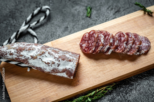 Fuet Catalan dry cured sausage cut in slices. Traditional Spanish Fuet thin dried sausage photo